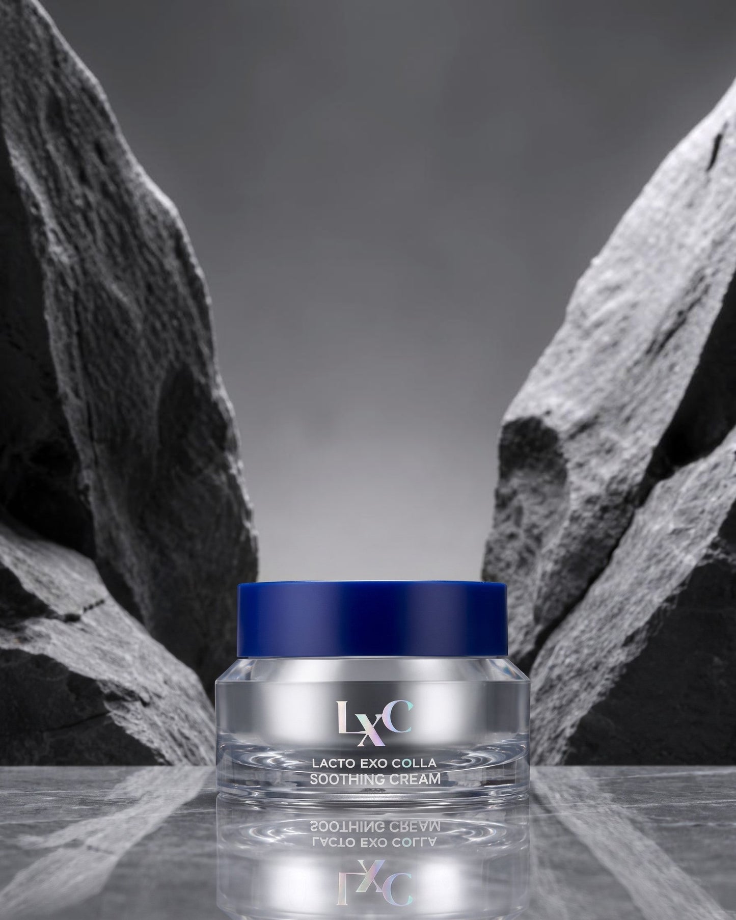 DIY Skincare Lab™ LXC Lacto Exo Colla Soothing Cream in a sleek glass jar with a blue lid, set against grey stone.