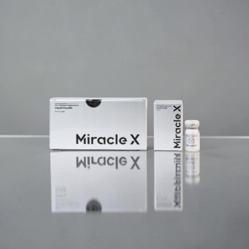 DIY Skincare Lab™ Miracle X skin booster set with white packaging boxes and a small glass vial on a reflective surface.
