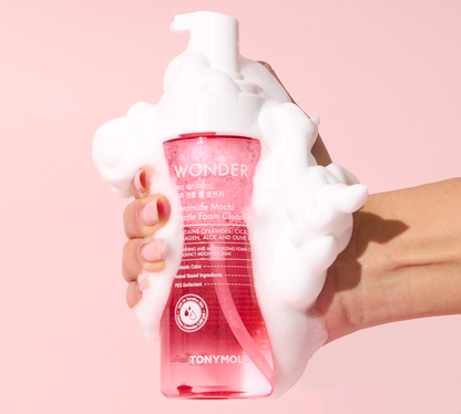 DIY Skincare Lab™ Wonder Ceramide Mochi Gentle Foam Cleanser bottle covered in thick white foam against pink background